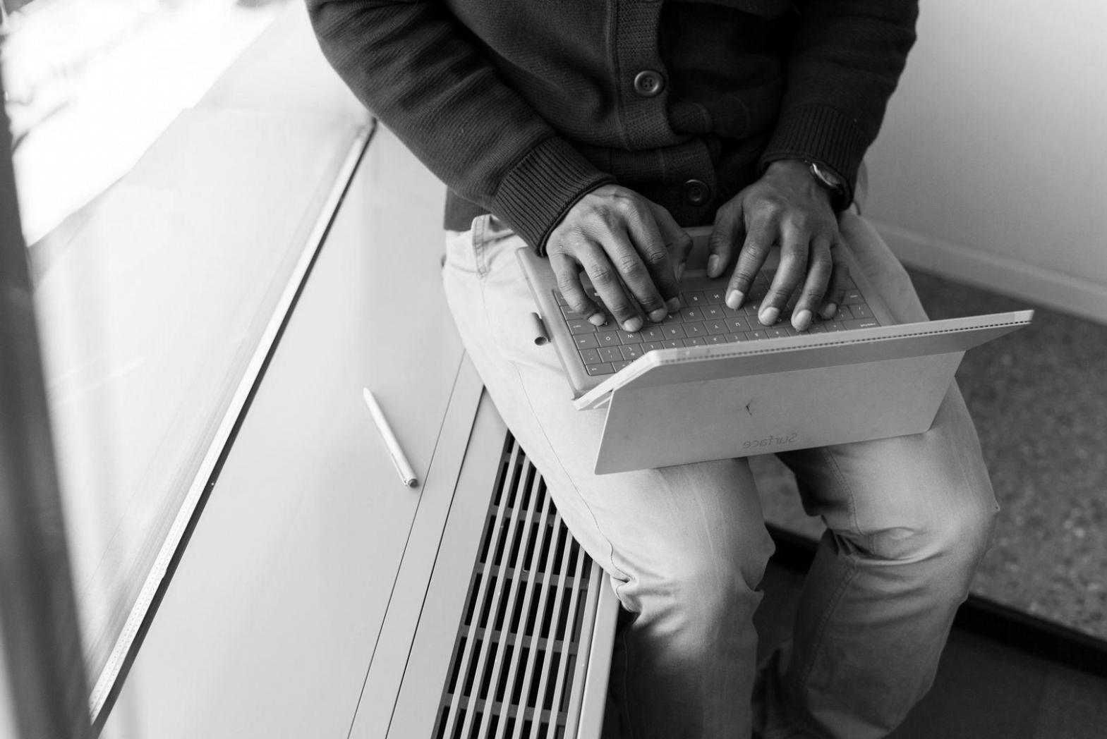 Person reviewing budget documents and planning financial goals